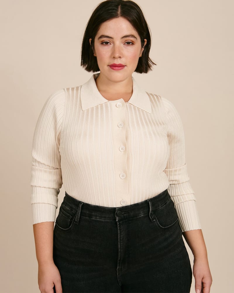 Front of a model wearing a size 1X Slim Rib Polo in TUSK by Good American. | dia_product_style_image_id:225742